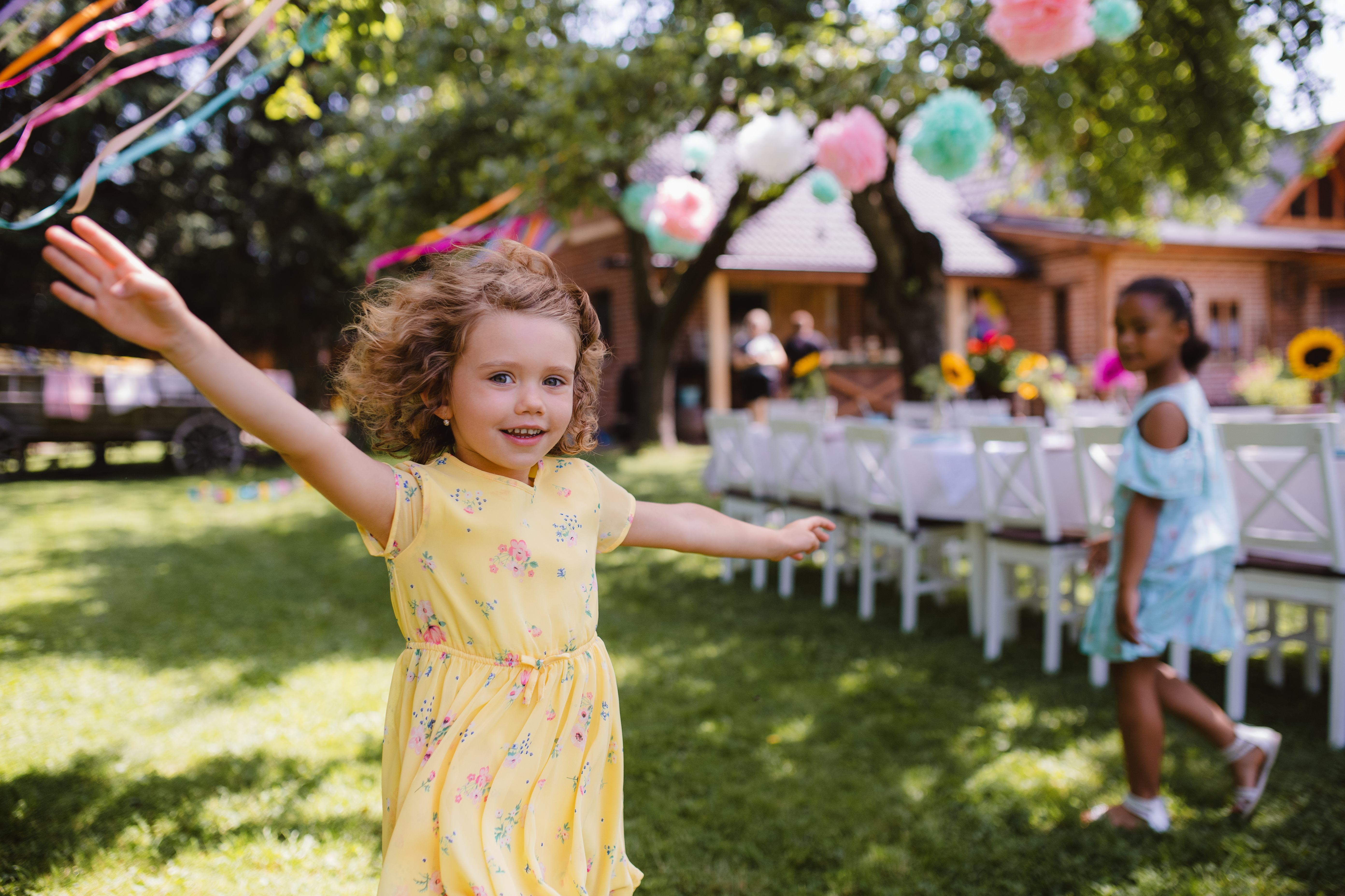 Small Girl Running Outdoors In Garden In Summer Birthday Celebration